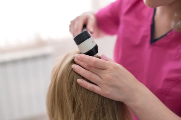 trichologist examins hair
