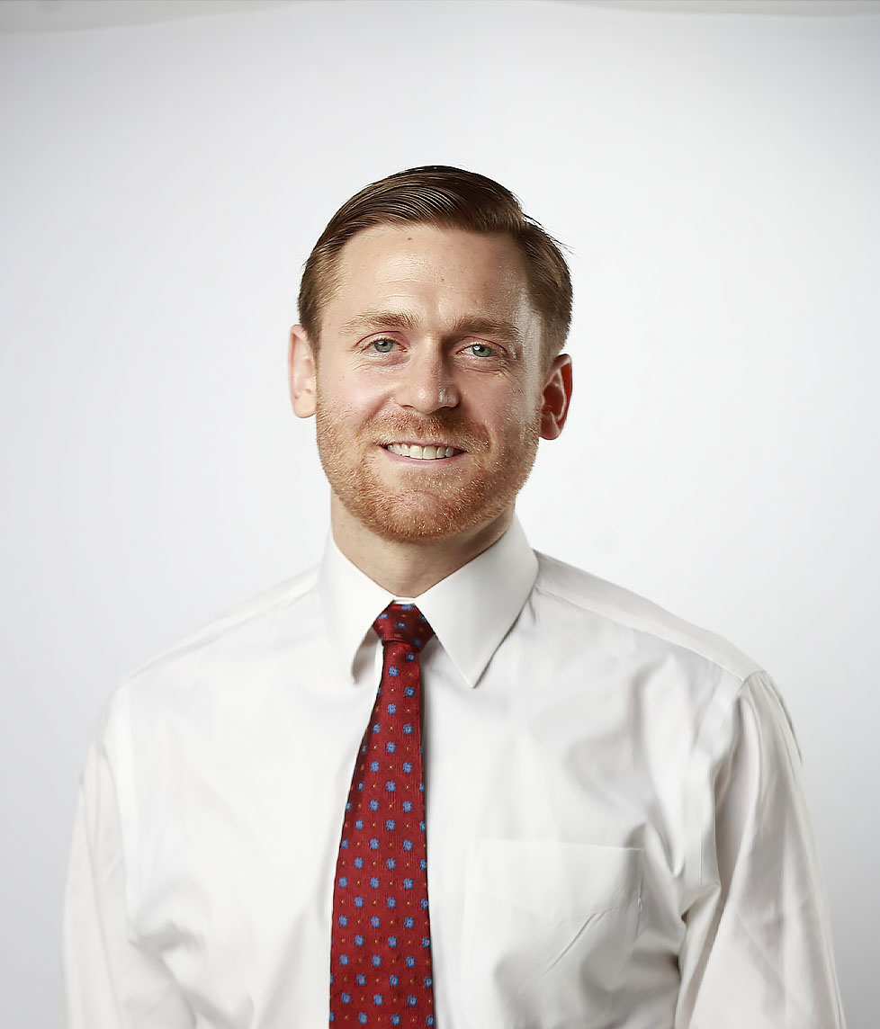 dr fischer in a white shirt and red tie
